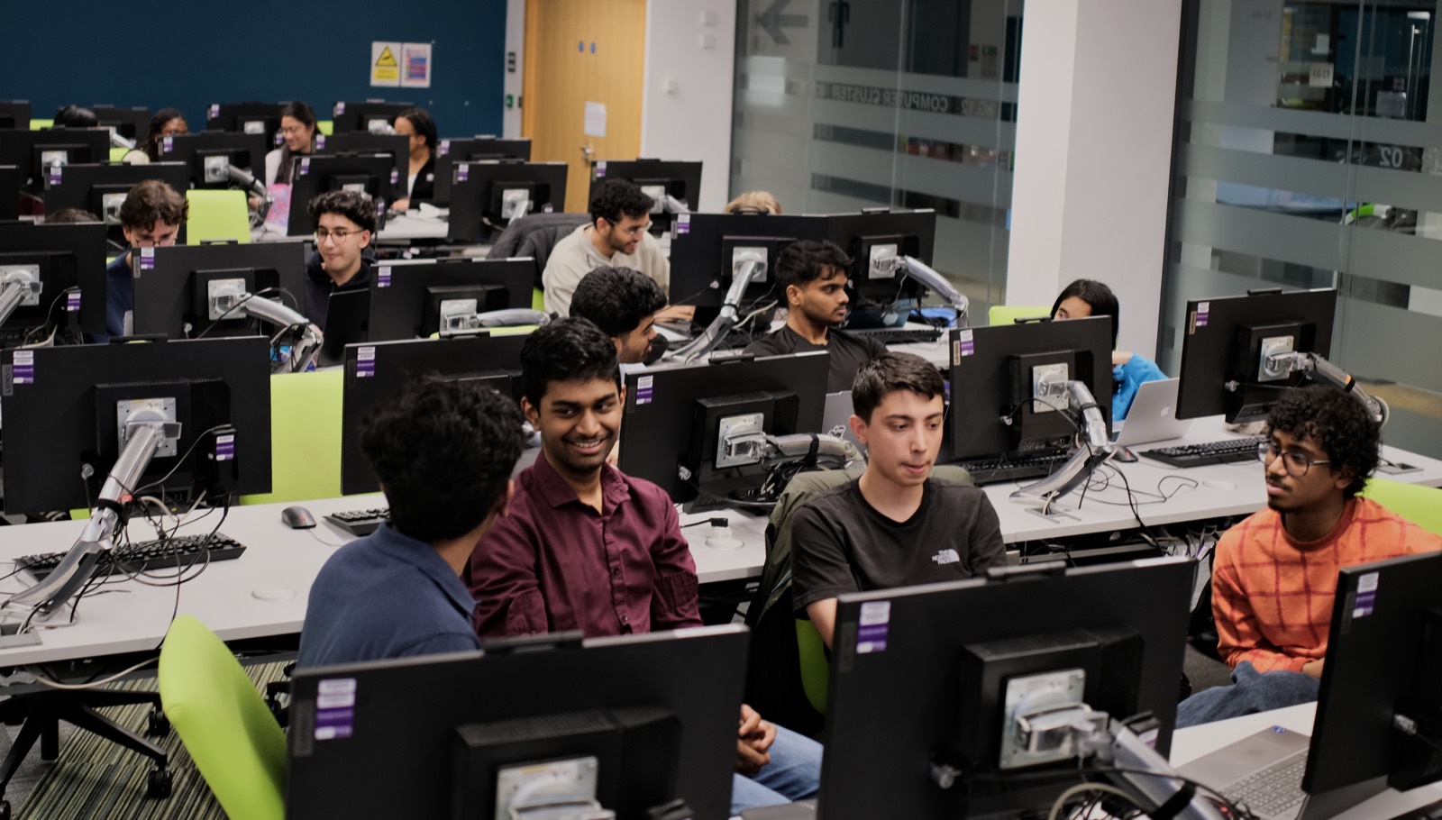 A lab full of Builders Club members working at rows of desks during a sprint