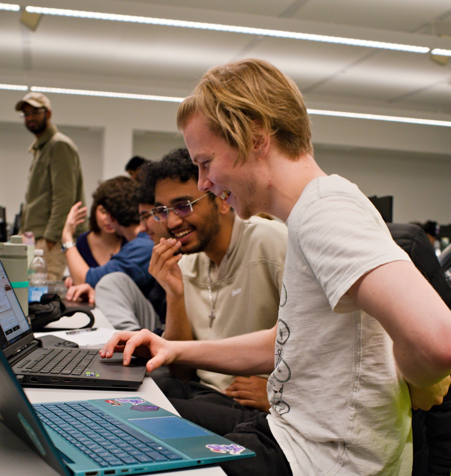 Two Builders Club participants smiling over a laptop